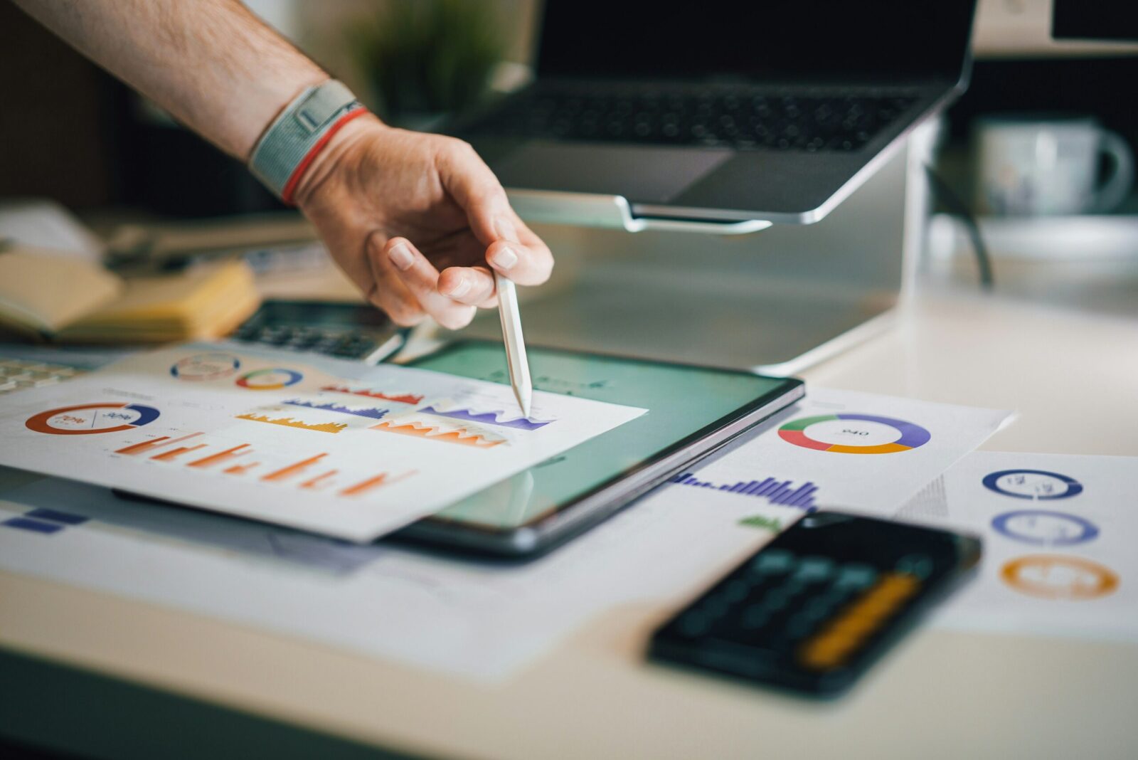 Unmasking the True Price of IT Downtime 3 a person is writing on a piece of paper